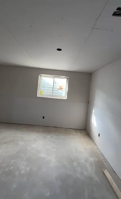 A walk through a basement from bare framing to every wall and the ceiling boarded.